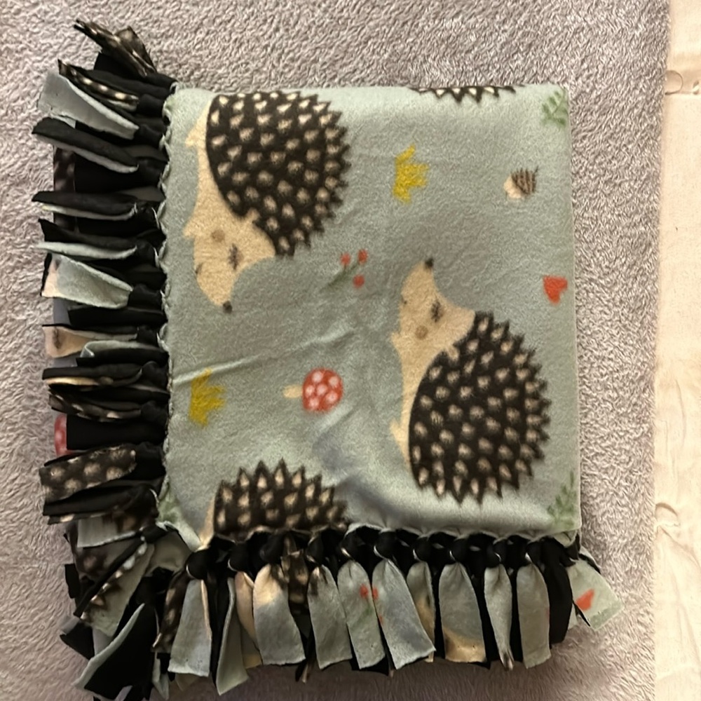 50x60” fleece tie blanket.  Porcupine pattern fleece with black fleece backing